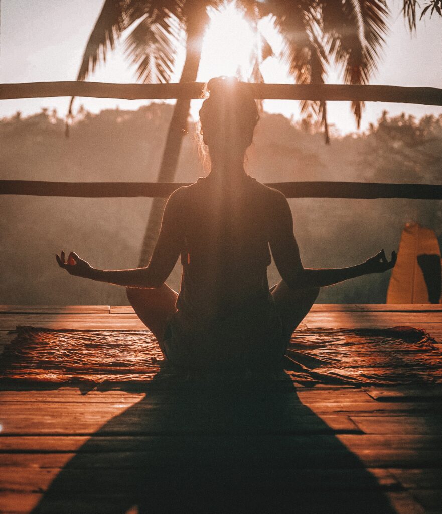 Person meditating near a palm tree, Meditation