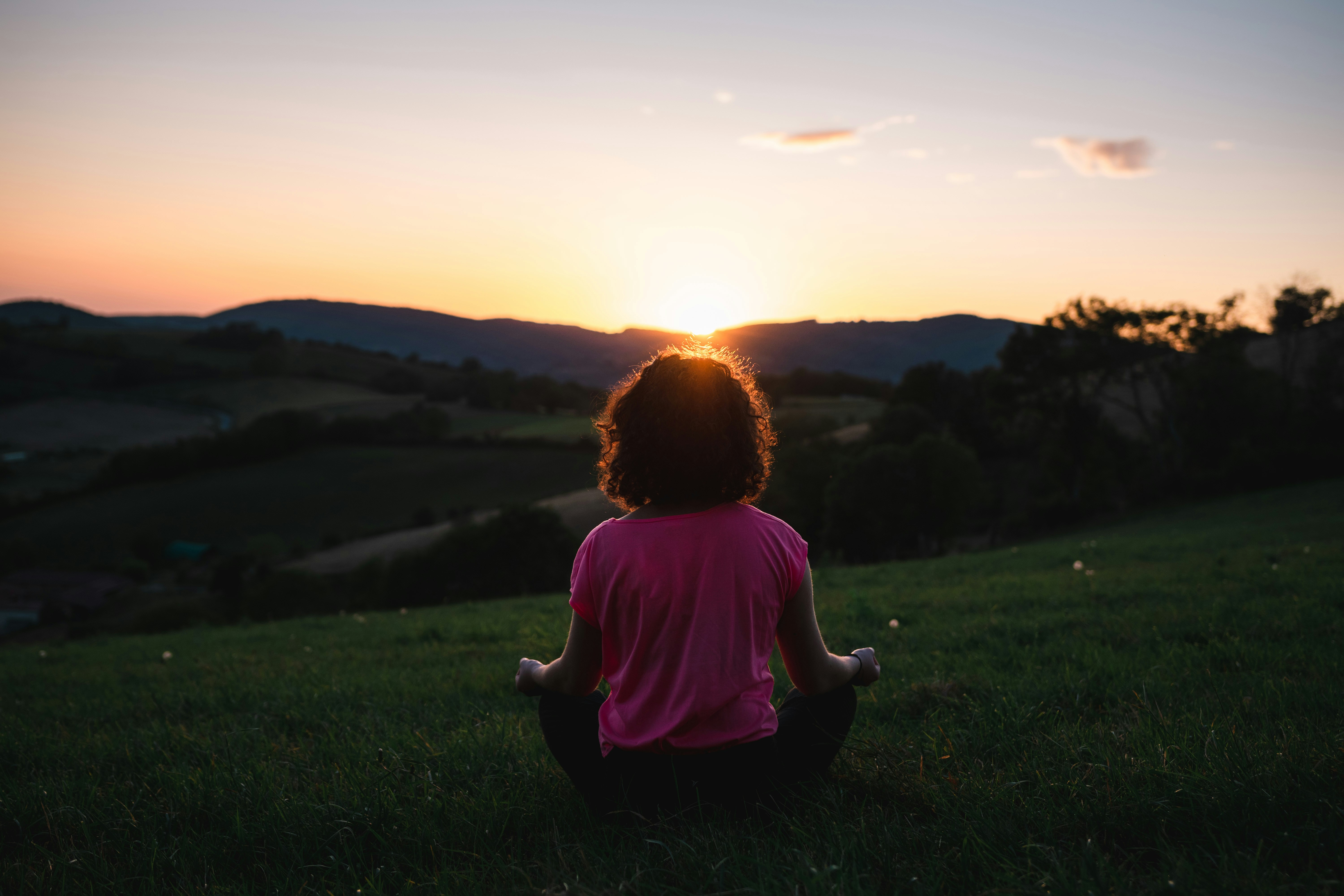 Person meditating outdoors